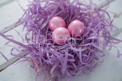 Pink Easter eggs in the violet nest
