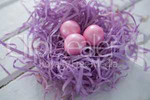 Pink Easter eggs in the violet nest