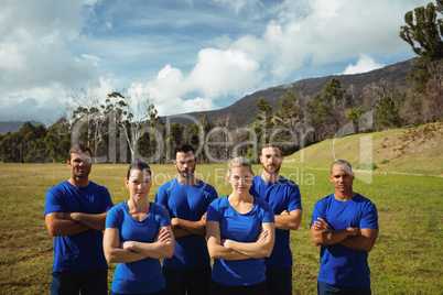 Group of people standing with arms crossed during boot camp training