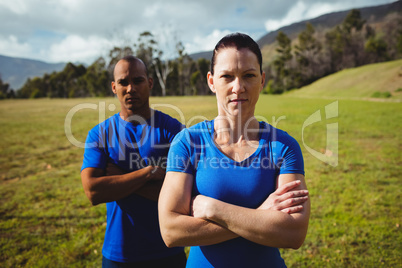 Couple standing with arms crossed during boot camp training