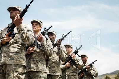Group of military soldiers standing with rifles
