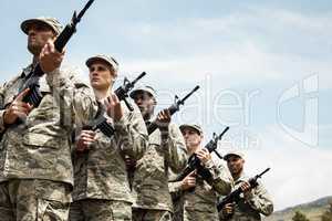 Group of military soldiers standing with rifles