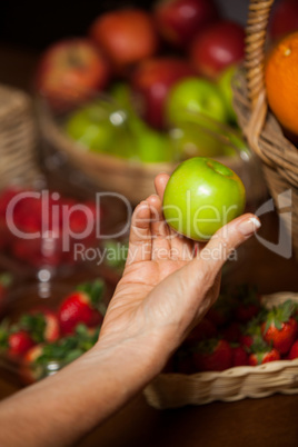 Hand of female staff holding a apple