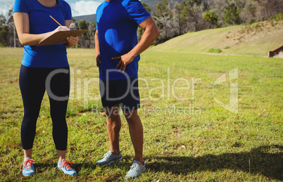Female trainer instructing a man in bootcamp