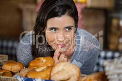 Smiling woman looking at breads in counter