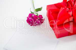 Gift box and pink flower with blank paper
