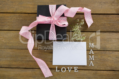 Gift box with mama love text on wooden plank
