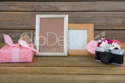 Gift box, photo frame, vintage camera and flower vase