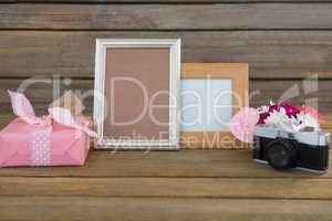 Gift box, photo frame, vintage camera and flower vase