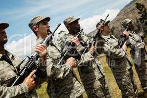 Group of military soldiers standing with rifles