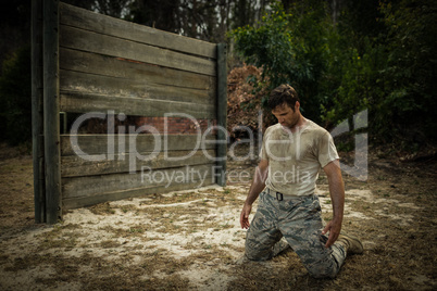 Soldier sitting on his knees