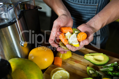 Staff holding chopped fruits at counter
