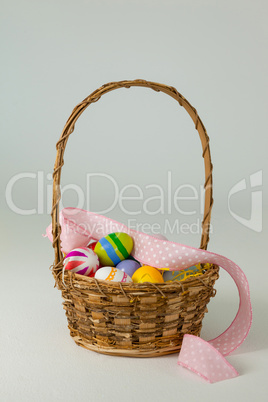 Various Easter eggs in wicker basket