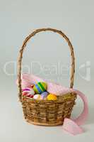 Various Easter eggs in wicker basket