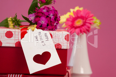 Happy mothers day card and flowers on gift boxes