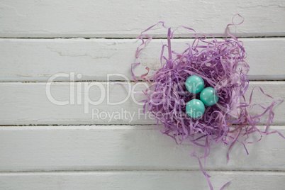 Turquoise Easter eggs in the violet nest
