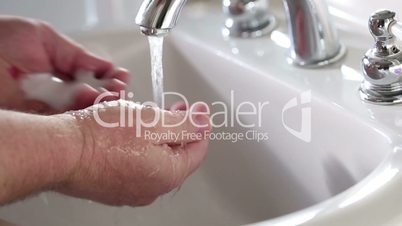 Slow Motion Clip of Man Washing His Hands in The Bathroom Sink