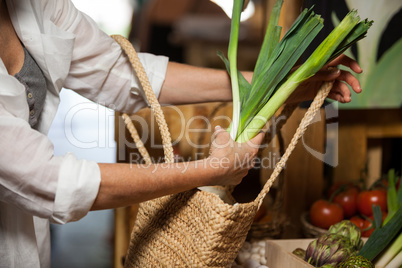 Woman buying leafy vegetable at organic section
