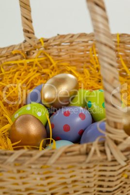 Various Easter eggs in wicker basket