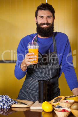 Portrait of male staff holding juice glass