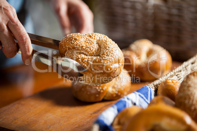 Hands of female staff holding sweet food with tongs