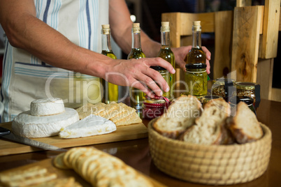 Olive oil, jam, pickle placed together on table