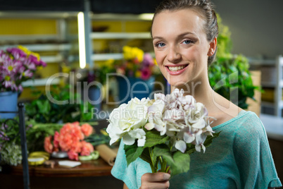 Portrait of woman holding a bunch of flowers