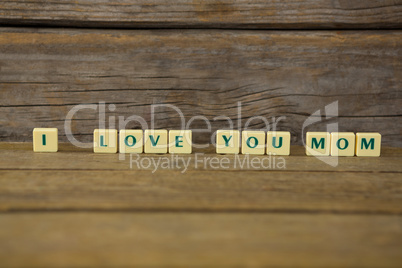 I love you mom block on wooden background