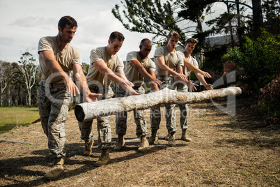 Soldiers dropping a tree log