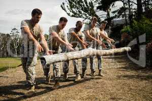 Soldiers dropping a tree log