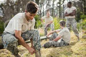 Soldier tying his shoe laces