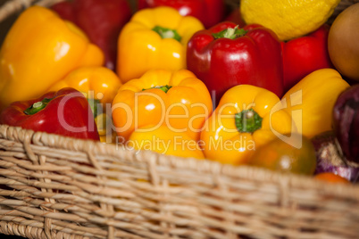 Close-up of fresh bell peppers in wicker basket at organic section