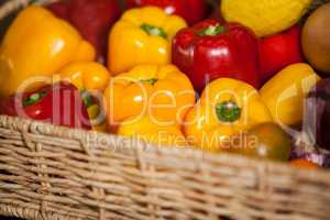 Close-up of fresh bell peppers in wicker basket at organic section