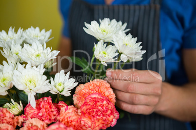 Florist holding flowers in florist shop