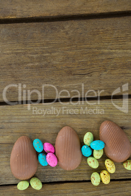 Chocolate Easter eggs on wooden plank