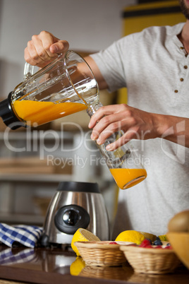 Male staff pouring juice in a bottle