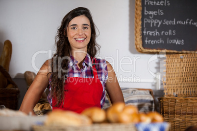 Portrait of female staff standing at bakery section