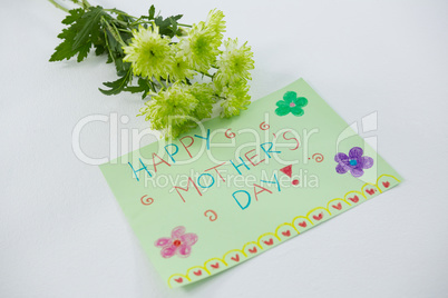 Close-up of happy mothers day card with flowers
