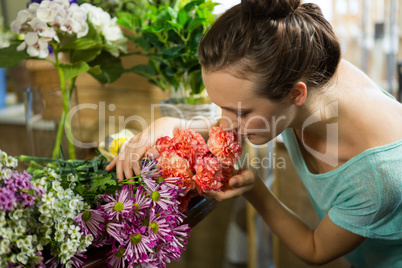 Woman smelling a bunch of flowers