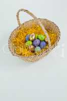 Various Easter eggs in wicker basket