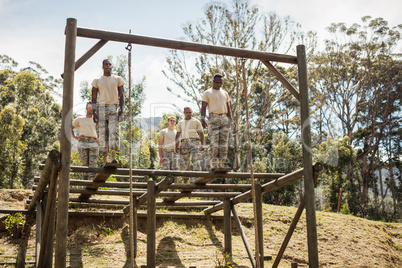 Military soldiers training rope climbing