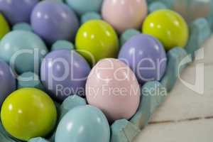 Multicolored Easter eggs in the carton