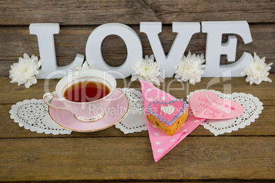 Cookies, tea, flowers and happy mothers day card with love text