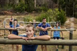 Group of people leaning on hurdles during obstacle training