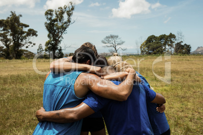 Fit people standing together and forming a hurdle