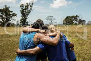 Fit people standing together and forming a hurdle