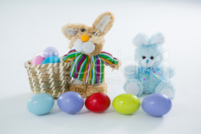 Basket with Easter eggs and two toy Easter bunny