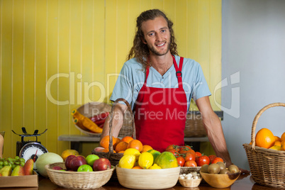 Portrait of smiling staff standing at counter