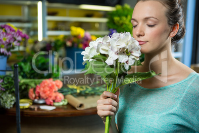 Woman smelling a bunch of flowers