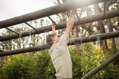 Soldier climbing monkey bars